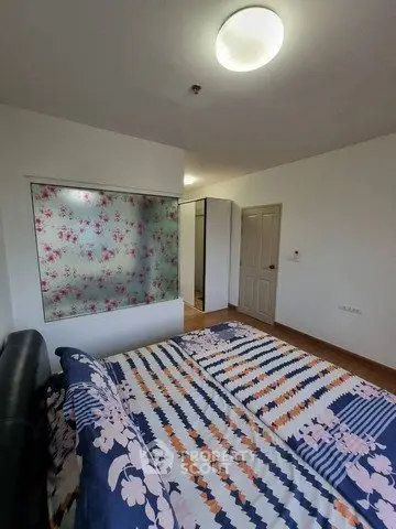 Cozy bedroom with floral decor and modern furnishings in a stylish apartment.