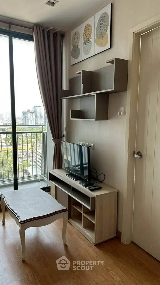 Modern living room with city view, stylish decor, and natural light