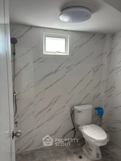 Modern bathroom with marble tiles and natural light