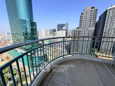 Stunning cityscape view from a spacious balcony in a high-rise building, perfect for urban living.