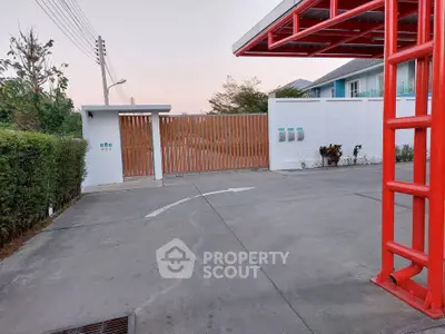 Modern gated entrance with sleek design and secure access in a residential area.