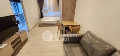 Modern studio apartment with cozy living area and kitchen view