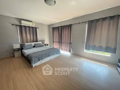 Spacious bedroom with modern design and ample natural light