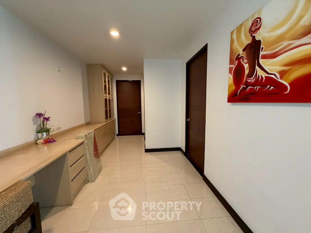 Spacious hallway with elegant decor and modern artwork