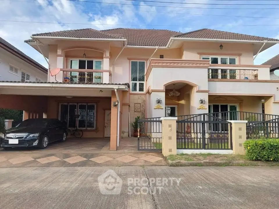 Elegant two-story house with carport and balcony in a serene neighborhood.