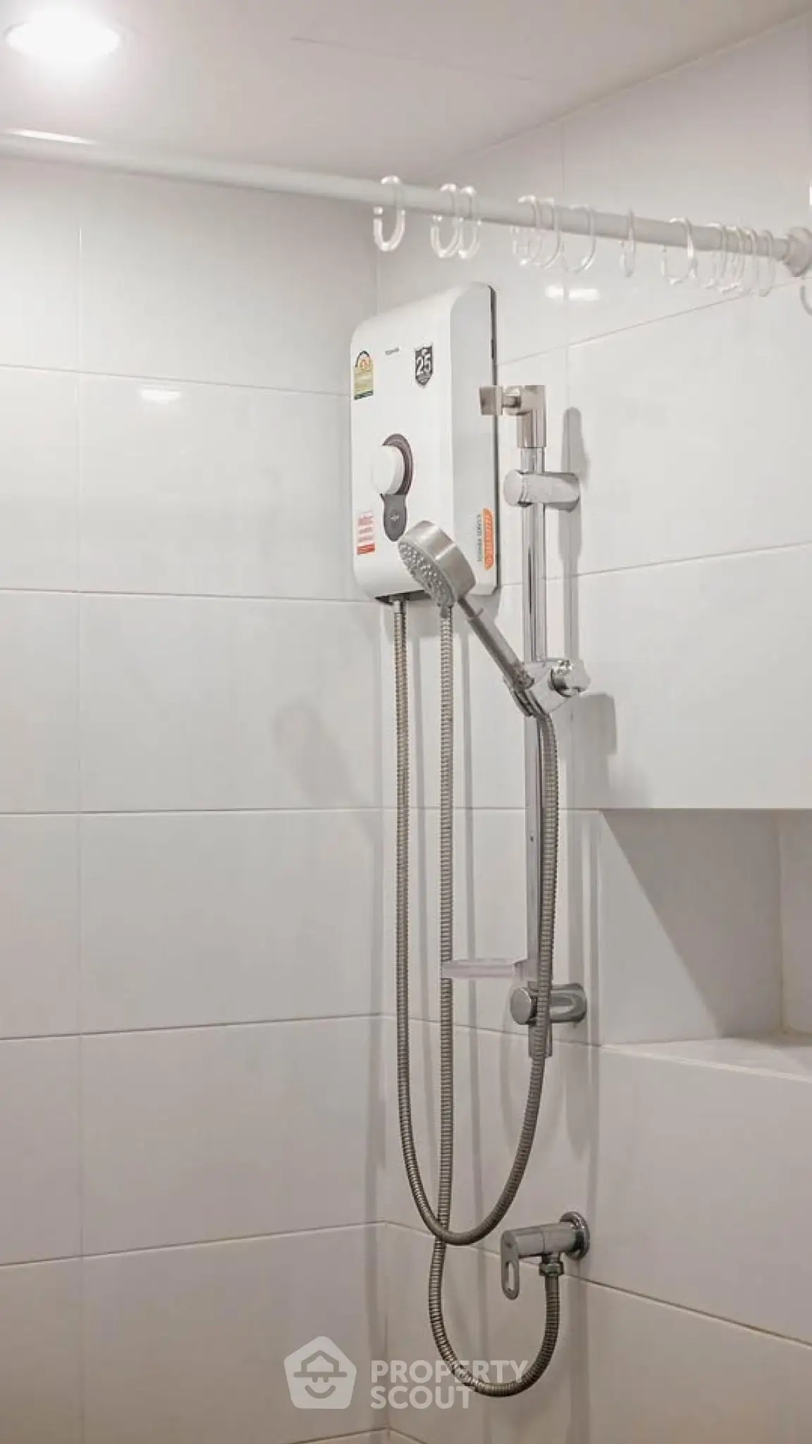 Modern bathroom with sleek shower unit and white tiled walls