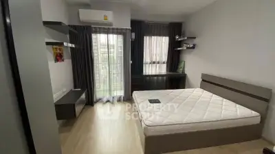 Modern bedroom with large window and minimalist furniture in a stylish apartment.