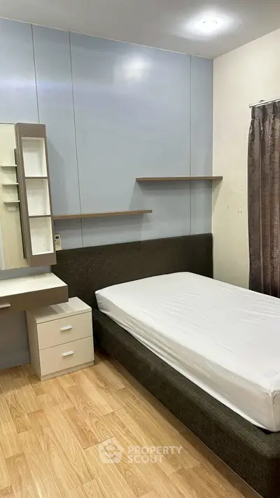 Cozy bedroom with modern furnishings and ample storage space.