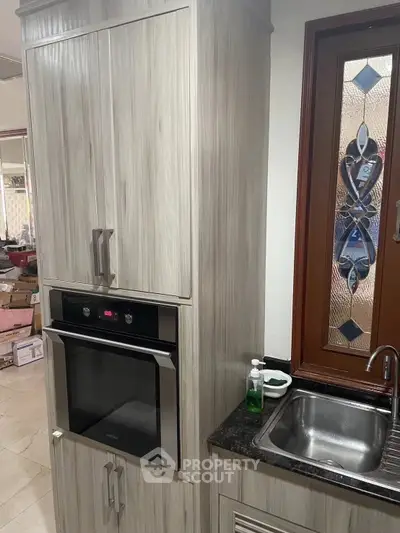 Modern kitchen with built-in oven and stylish cabinetry