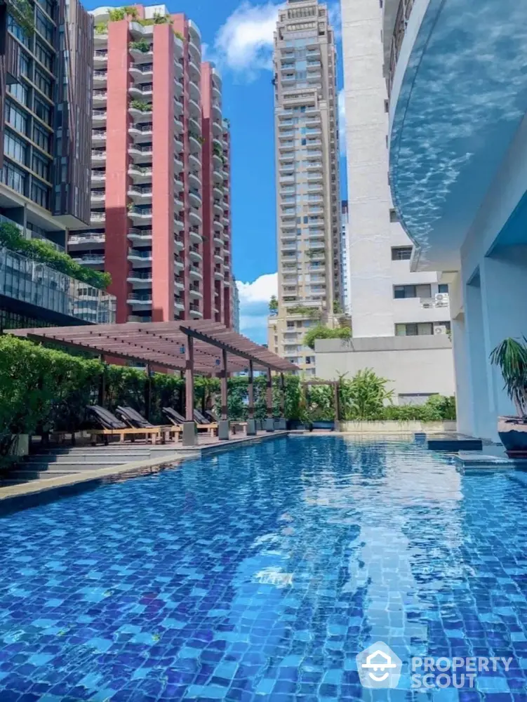 Luxurious residential pool with stunning cityscape views and modern architecture.