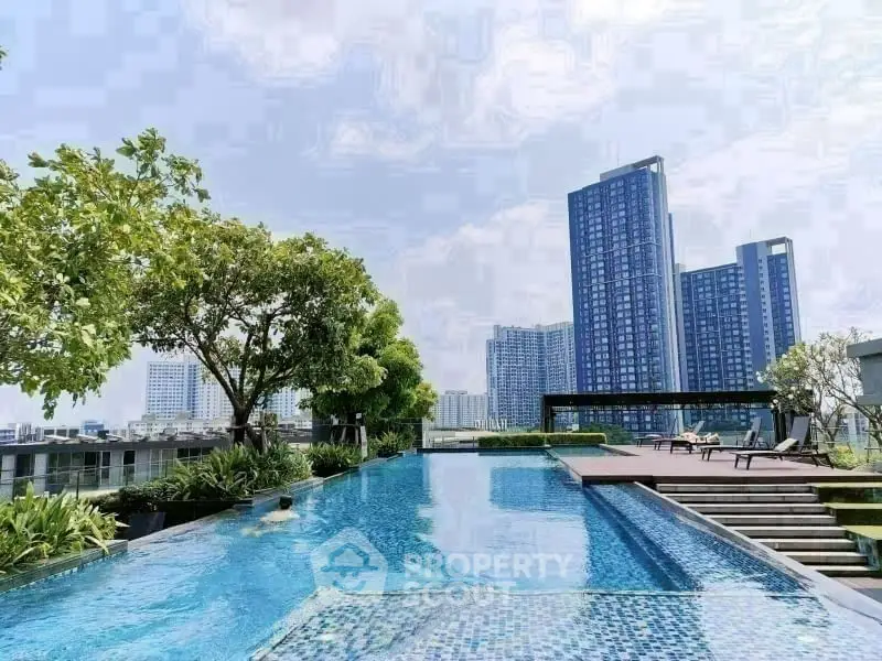 Luxurious rooftop pool with stunning city skyline views and lush greenery.