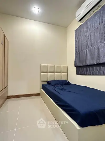 Cozy minimalist bedroom with single bed and air conditioning