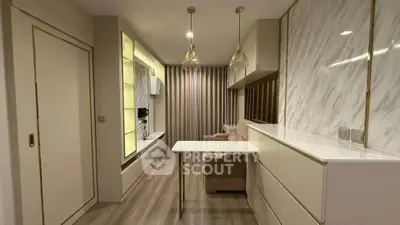 Modern living room with elegant marble accents and stylish lighting in a compact apartment.