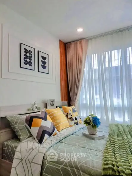 Stylish bedroom with modern decor and large window for natural light