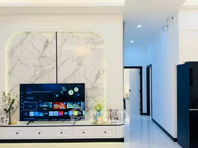 Modern living room with marble accent wall and sleek TV setup