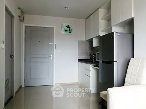 Modern compact kitchen with sleek appliances and minimalist design