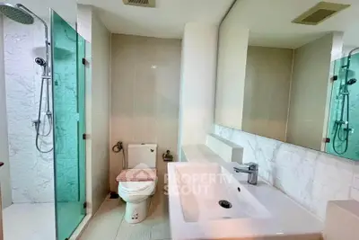 Modern bathroom with glass shower and sleek sink design