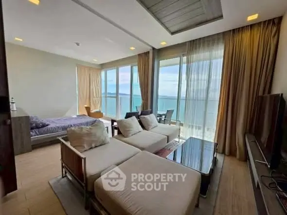 Luxurious beachfront living room with stunning ocean view and modern decor.