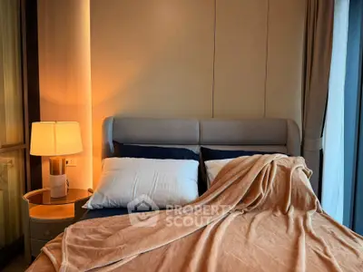 Cozy bedroom with elegant lighting and plush bedding, perfect for relaxation and comfort.