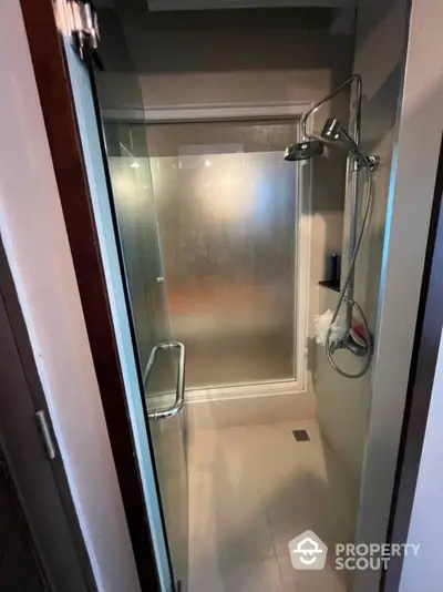 Modern bathroom with glass shower enclosure and sleek fixtures, offering a clean and minimalist design perfect for urban living.