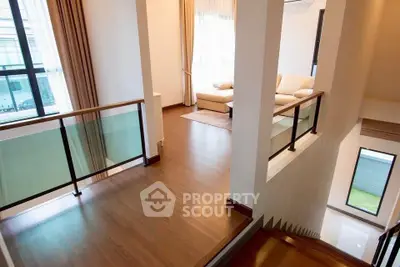 Elegant modern living room with wooden flooring and large windows