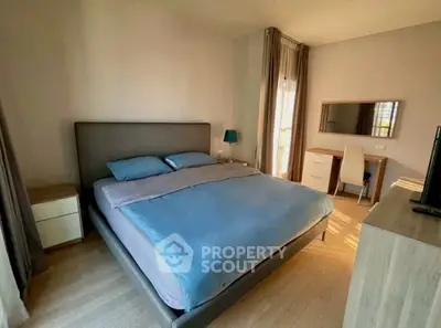 Spacious bedroom with modern furnishings and natural light, perfect for relaxation and comfort.