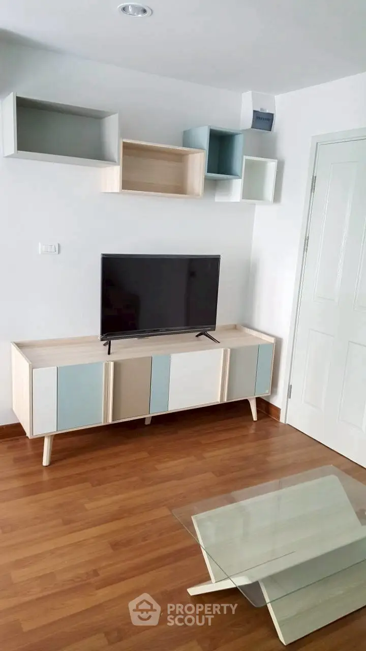 Modern living room with stylish TV stand and wall-mounted shelves