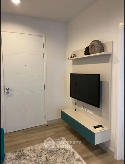 Modern living room with wall-mounted TV and stylish decor