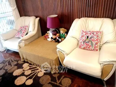 Cozy living room with plush armchairs and decorative pillows