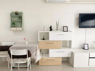 Modern living room with stylish furniture and wall-mounted TV, perfect for cozy gatherings.