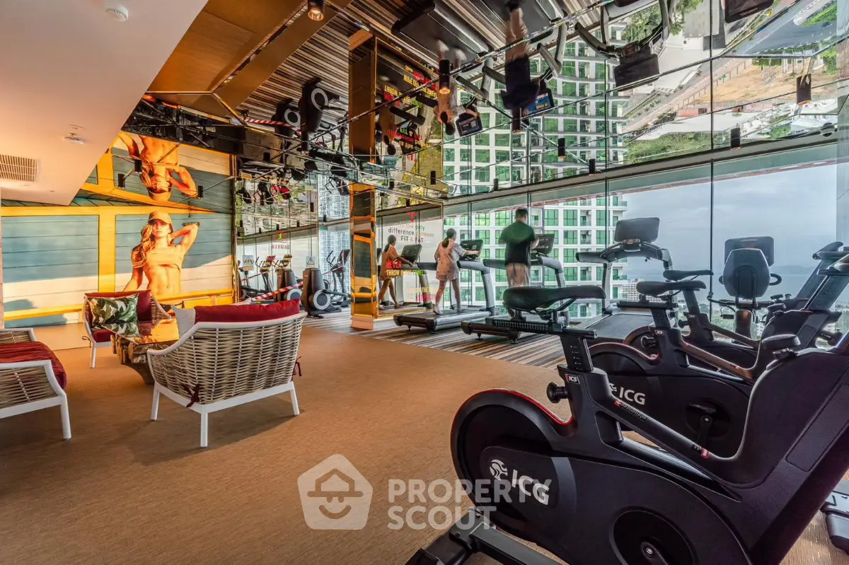 Luxurious high-rise gym with panoramic city views and modern fitness equipment.