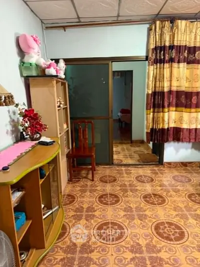 Charming living room with vintage decor and patterned flooring, perfect for cozy gatherings.