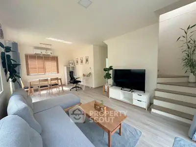 Spacious modern living room with cozy seating and natural light