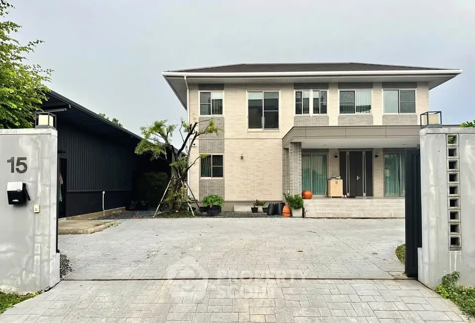 Modern two-story house with spacious driveway and contemporary design