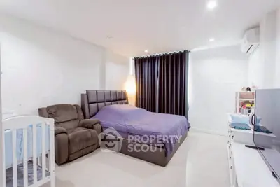Spacious bedroom with modern furnishings and ample natural light.