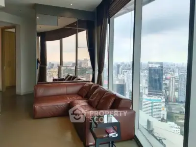 Luxurious living room with panoramic city view and elegant leather sofa.