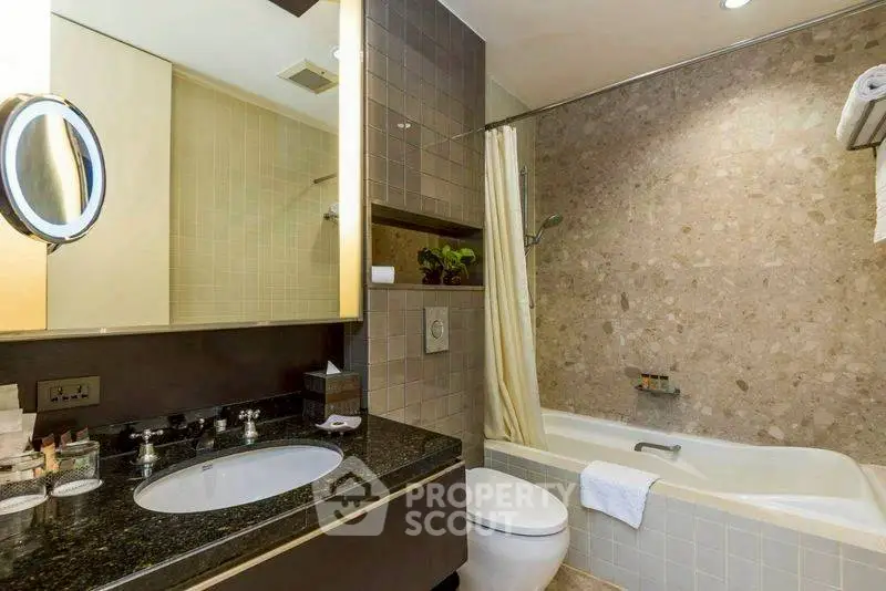 Modern bathroom with elegant fixtures and a cozy bathtub, perfect for relaxation.