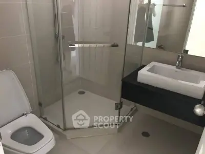 Modern bathroom with glass shower and sleek sink design