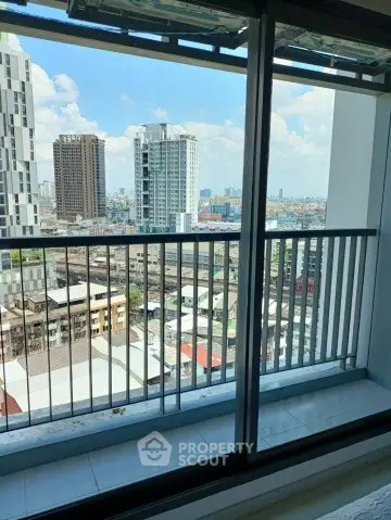 Stunning city view from high-rise balcony with modern railing design.