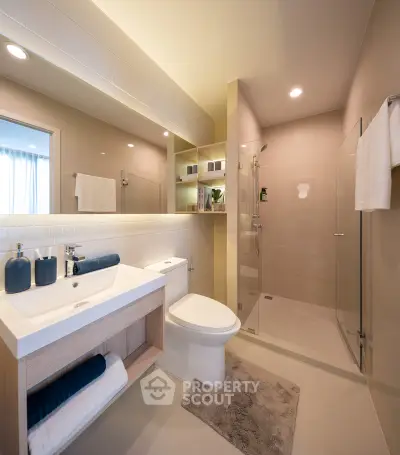 Modern bathroom with sleek design, glass shower, and elegant fixtures.