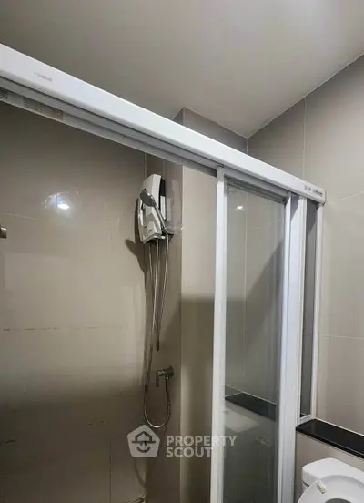 Modern bathroom with sliding glass shower door and sleek fixtures