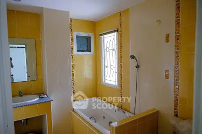 Charming bathroom with yellow tiles and built-in bathtub
