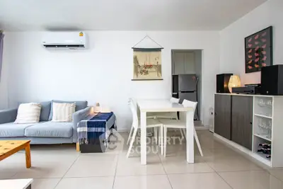 Modern living room with sleek furniture and air conditioning in a bright, open space.