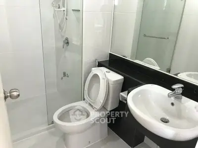 Modern bathroom with sleek fixtures and glass shower enclosure