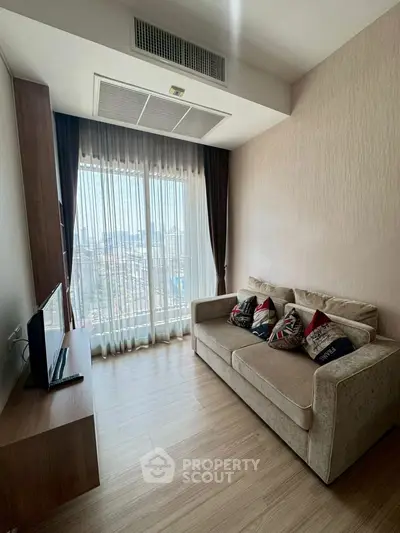 Modern living room with cozy sofa and large window offering city view