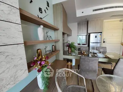 Modern dining area with stylish decor and open kitchen layout in a contemporary apartment.