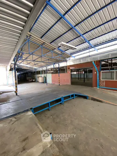 Spacious industrial warehouse with high ceilings and loading dock