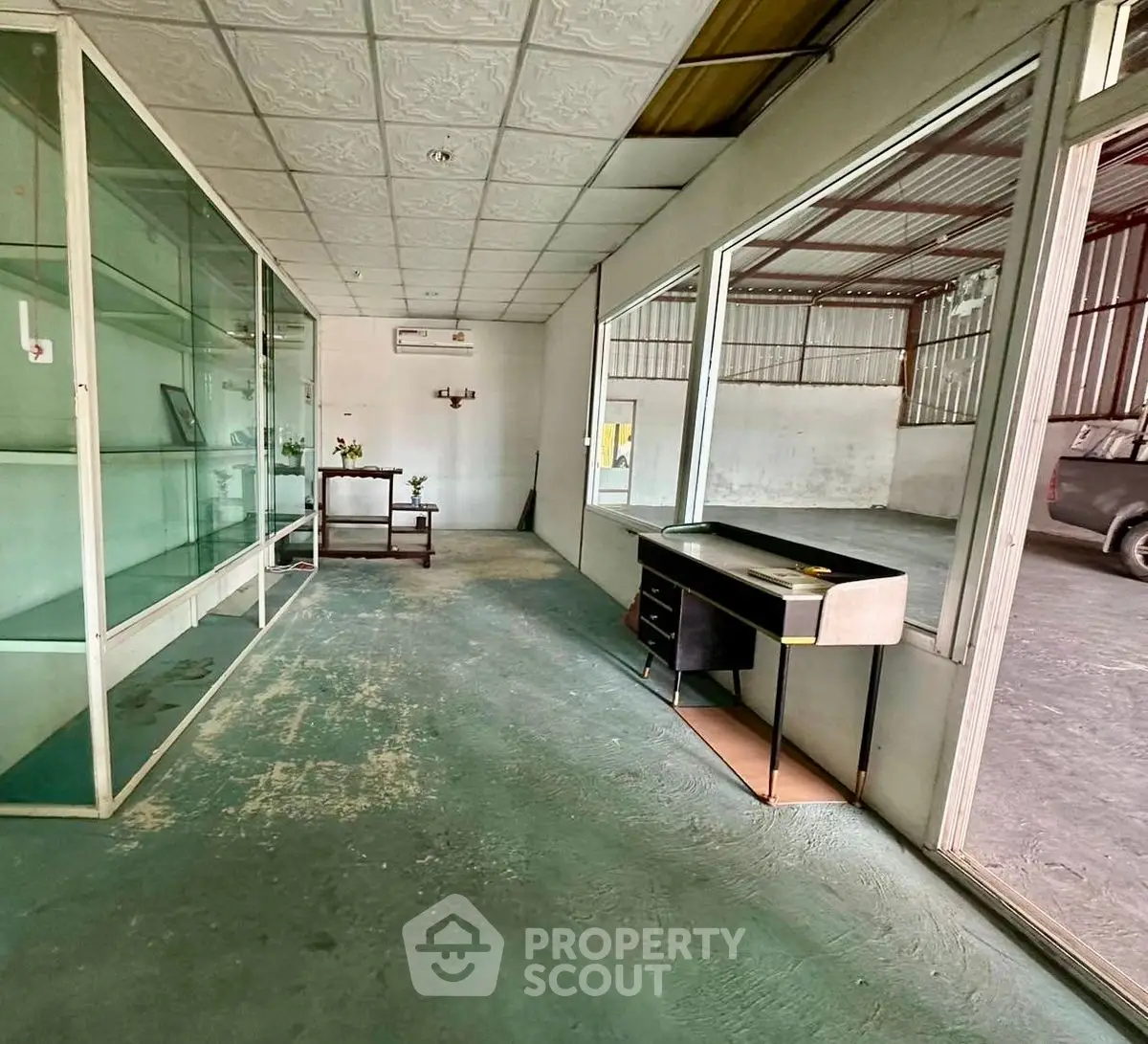 Spacious commercial space with glass partitions and ample natural light
