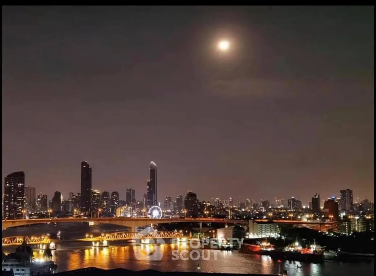 Stunning city skyline view with illuminated skyscrapers and river at night, perfect for urban living.