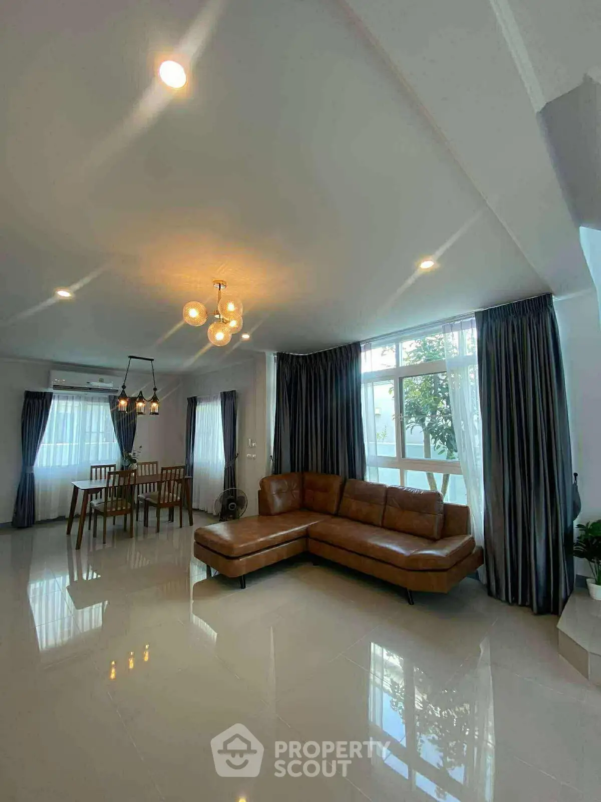 Spacious living room with modern decor and large windows for natural light.